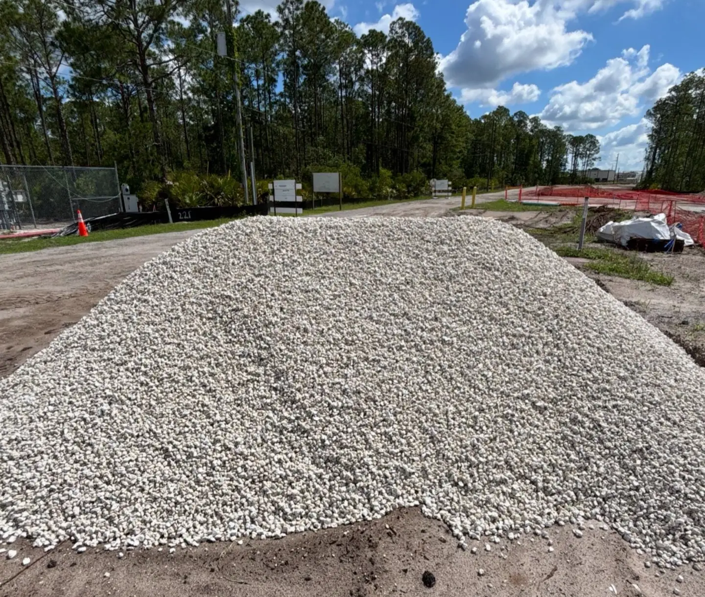 Pile of #57 stone base material delivered for a road and driveway project in Central Florida