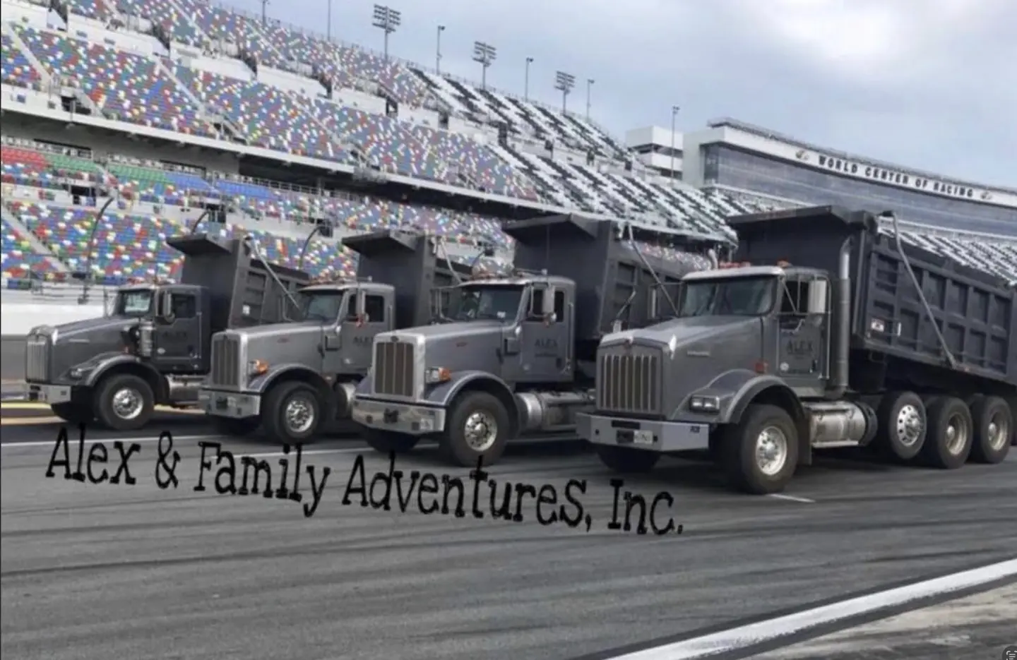 Alex and Family Trucking dump truck fleet lined up at Daytona International Speedway