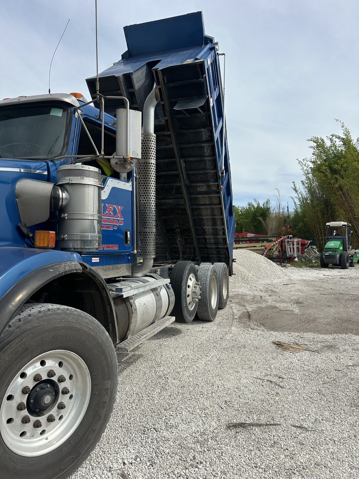 Alex and Family Trucking dump truck delivering FDOT approved #57 limestone in Orlando, Florida