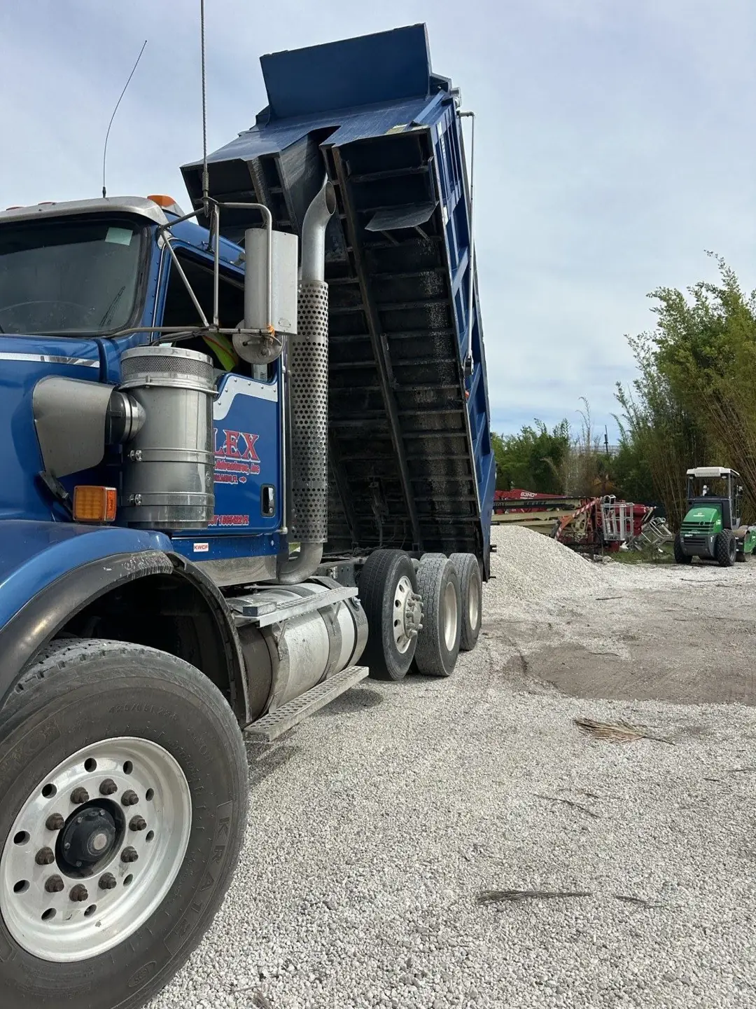Alex and Family Trucking dump truck delivering FDOT approved #57 limestone in Orlando, Florida
