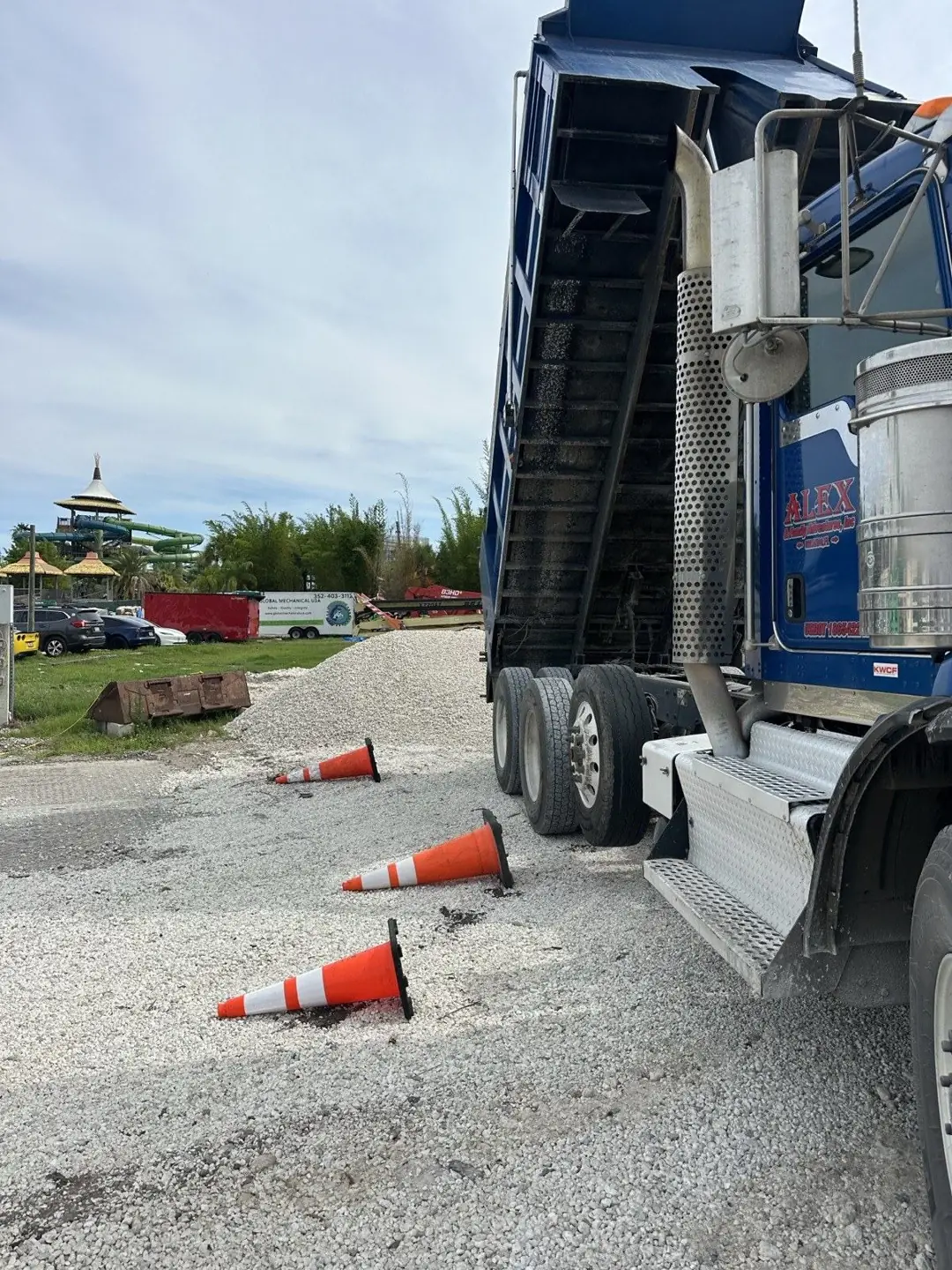 Dump truck unloading a fresh pile of #57 crushed limestone at a Central Florida job site