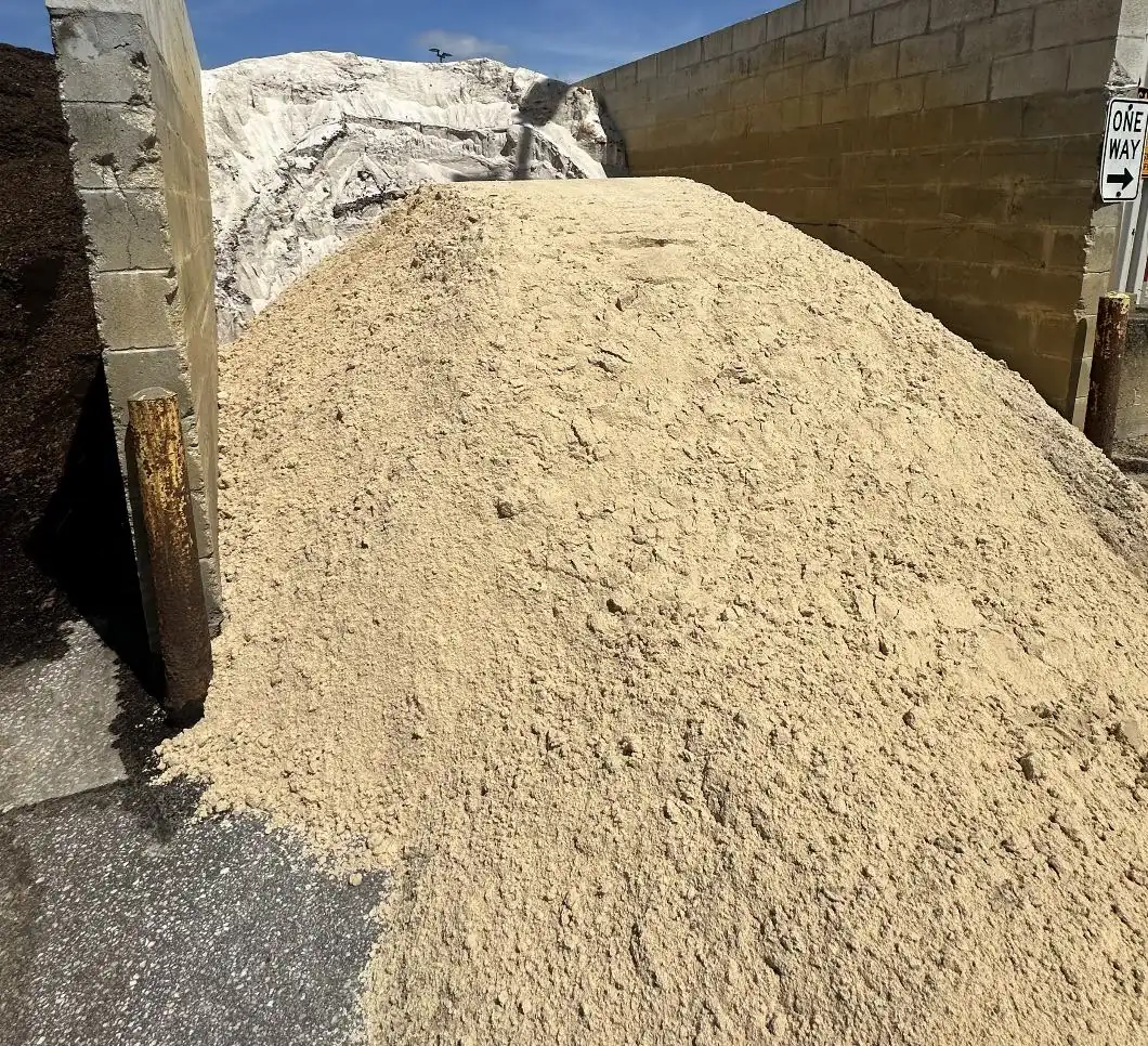 Pile of clean washed septic sand at a Central Florida material yard, ready for drainfield delivery by Alex and Family Trucking